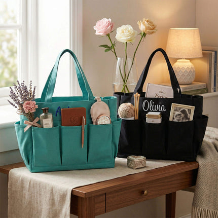 Two organizer tote bags, one mint and one black, on a wooden surface with flowers and items.