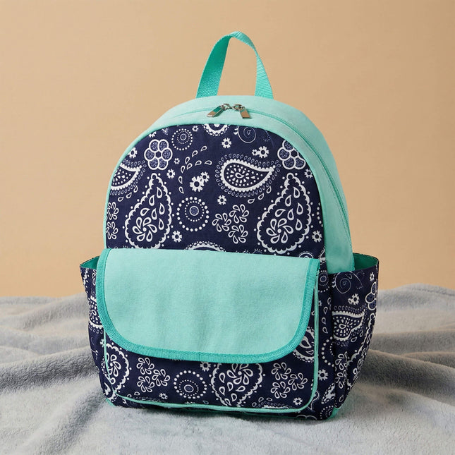 Red To Purple personalized preschool backpack features a navy-white paisley pattern, with a solid mint front flap pocket and trim, resting on a textured grey carpet.