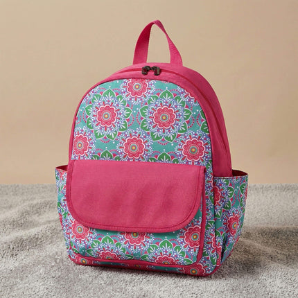 Red To Purple personalized preschool backpack features a vibrant turquoise and pink medallion floral pattern, with a solid pink front flap pocket and trim, resting on a textured grey carpet.