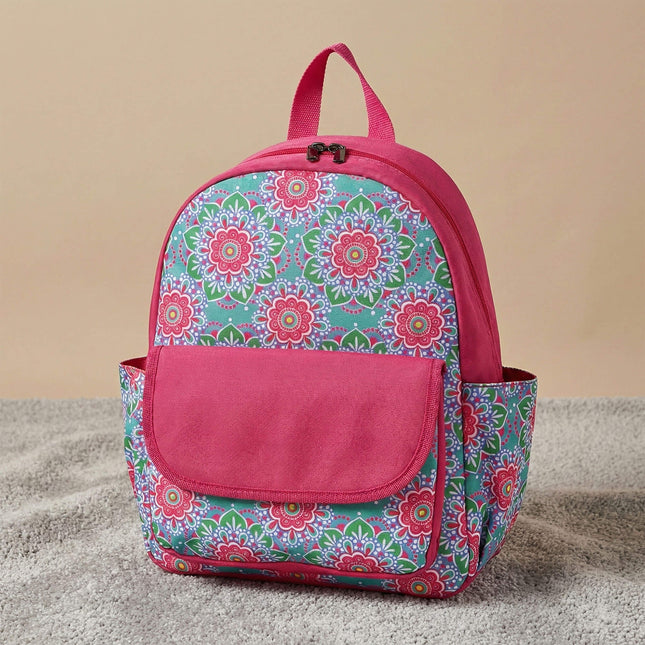 Red To Purple personalized preschool backpack features a vibrant turquoise and pink medallion floral pattern, with a solid pink front flap pocket and trim, resting on a textured grey carpet.